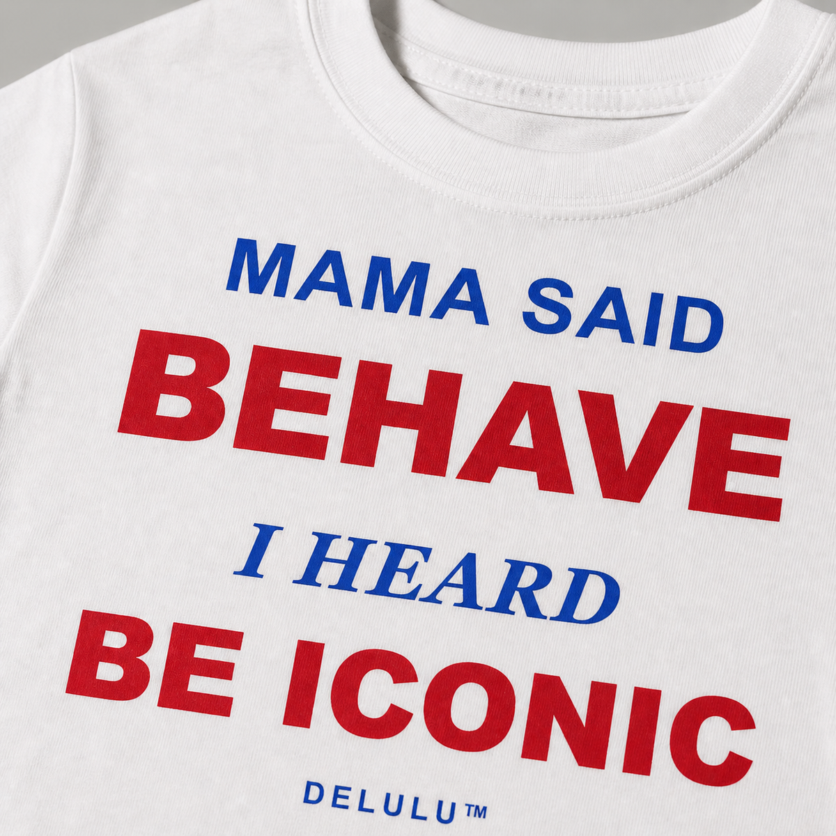Close-up of red and cobalt Mama Said Behave kids T-shirt print