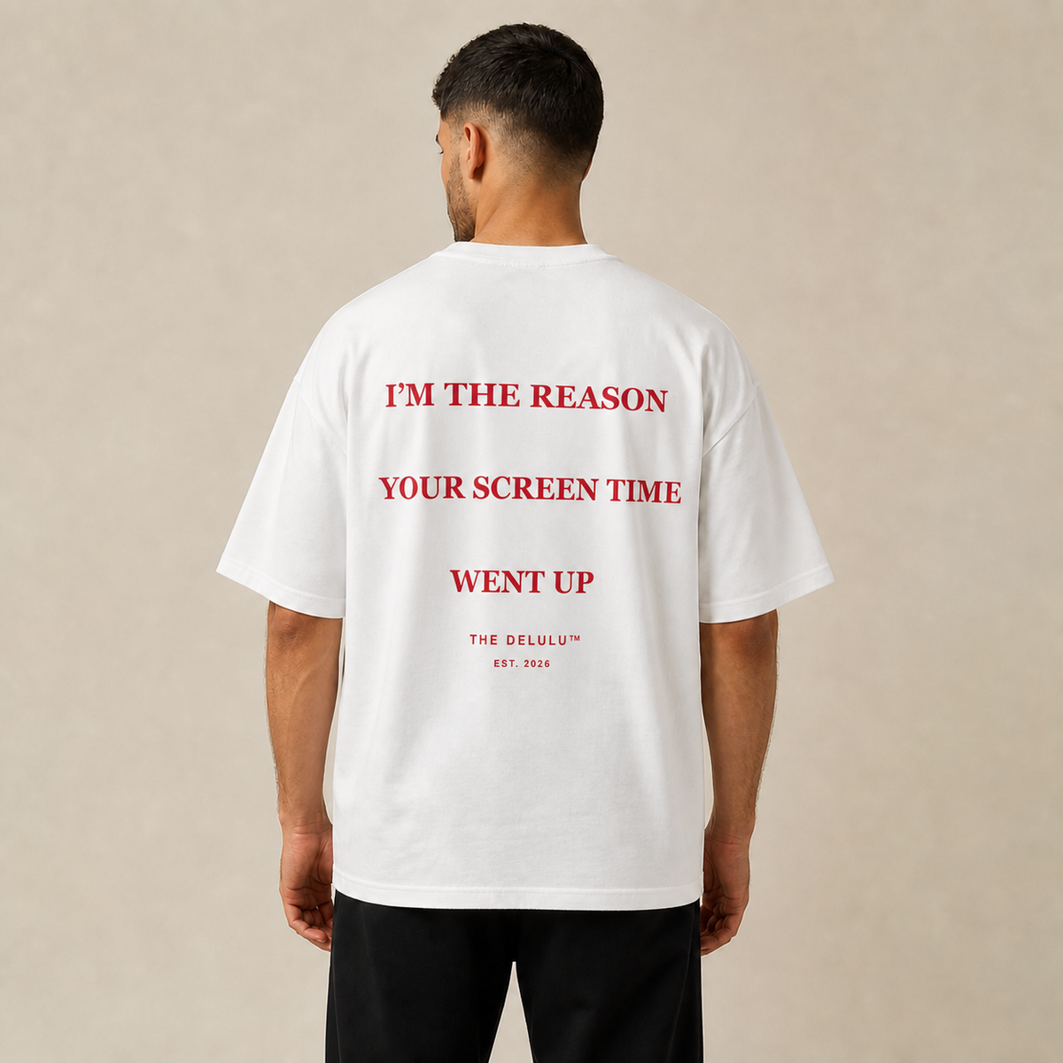 Model wearing white DELULU Screen Time oversized T-shirt, back view